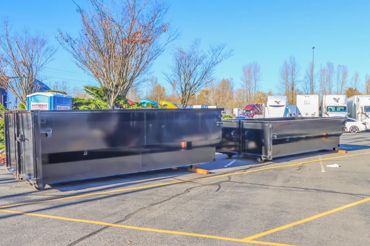 Professional dumpster rental service with roll-off container on residential driveway in Hackettstown